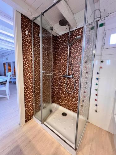 a shower in a room with a glass wall at Downtown Dreams in Madrid