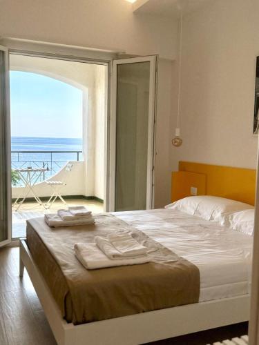 a bedroom with a bed with a view of the ocean at Finestra sul mare Diamante in Diamante