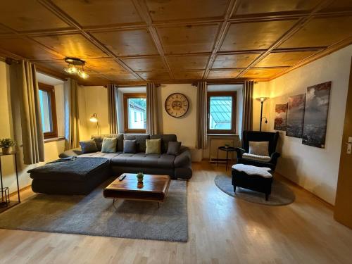a living room with a couch and a table at Ferienwohnung mit Kamin und Balkon in Samnaun