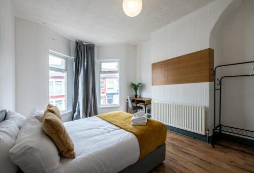 a bedroom with a bed and a large window at 4BR Home in Great Location close to Transport in Liverpool