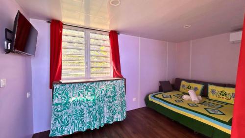 a small room with a bed and a window at MOOREA - Bungalow Nauhei Surf Spot 2 in Haapiti