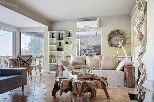 a living room with a couch and a table at LES OLIVIERS Villa for 6 By Sunset in Grasse