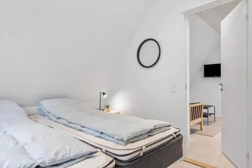 Camera bianca con letto e specchio di 1106-ringkobing-Klitrosevej-4 a Nørby
