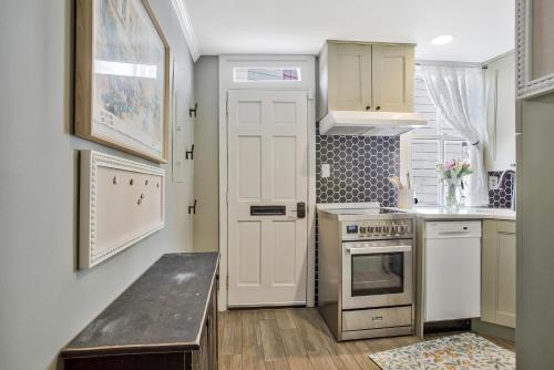 a kitchen with white cabinets and a white door at Historic Row Home in Downtown Annapolis in Annapolis