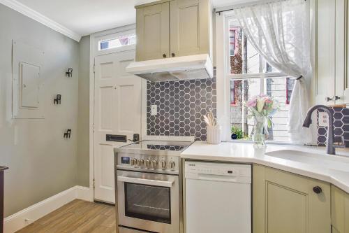 a kitchen with a stove and a sink and a window at Historic Row Home in Downtown Annapolis in Annapolis