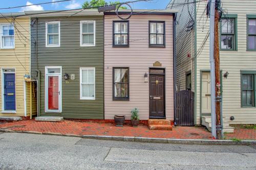 a green house with a red door on a street at Historic Row Home in Downtown Annapolis in Annapolis