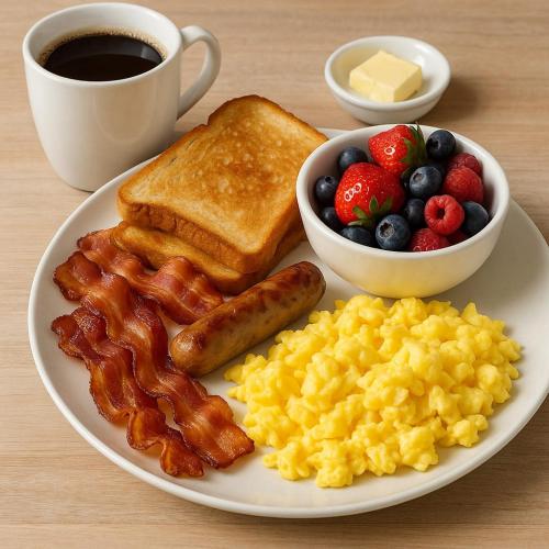 a plate of breakfast food with bacon eggs scrambled eggs and toast at Hotel Elite rooms & Banquet in Prayagraj