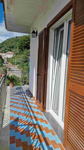 a balcony of a house with a tiled floor at CASA VACANZE - Anna Holiday Home in Tramonti