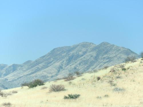 a hillside with a mountain in the background at Carlo's Mountain Lodge in Usakos