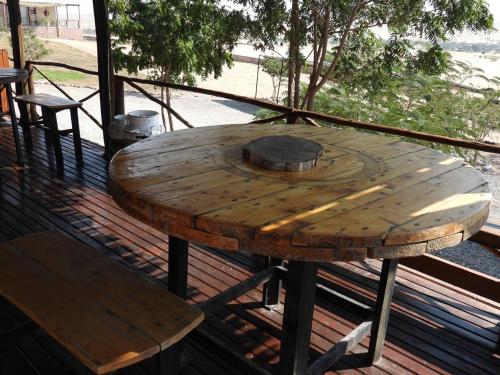 a wooden table on top of a deck at Carlo's Mountain Lodge in Usakos