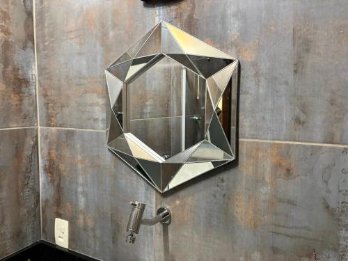 a mirror on the wall of a bathroom at Apto aconchegante e familiar em BC in Balneário Camboriú