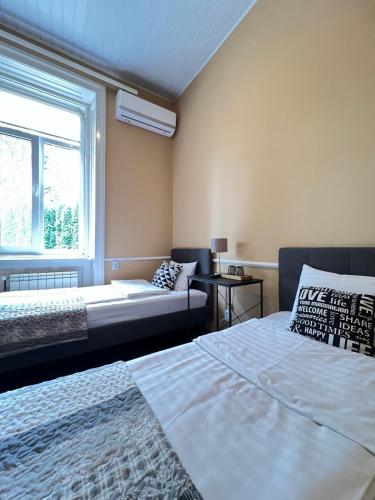 a bedroom with two beds and a window at Kavaler inn hotel in Kuty