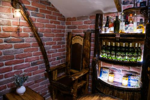 a room with a brick wall and shelves of alcohol at Apartmani Petra i Tea in Krapina
