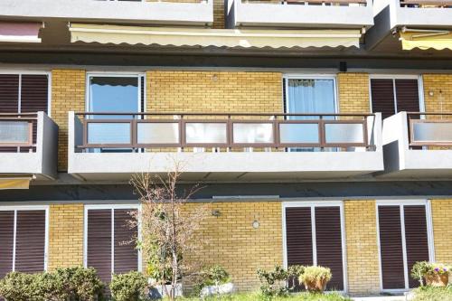 a brick building with a balcony on it at Sunny Bay Beachfront Retreat in Mola Kalyva