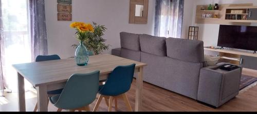 a living room with a table and a couch at PISO NAVAS 2 in Navas de San Antonio