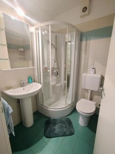 a bathroom with a shower and a toilet and a sink at Marina View Apartment Izola in Izola