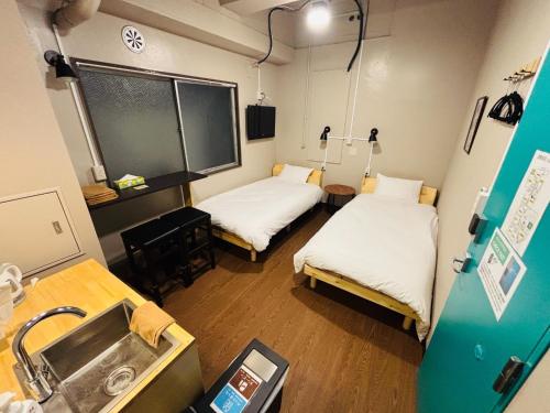a hospital room with two beds and a sink at Wasabi Mita Hotel - Vacation STAY 84674v in Tokyo