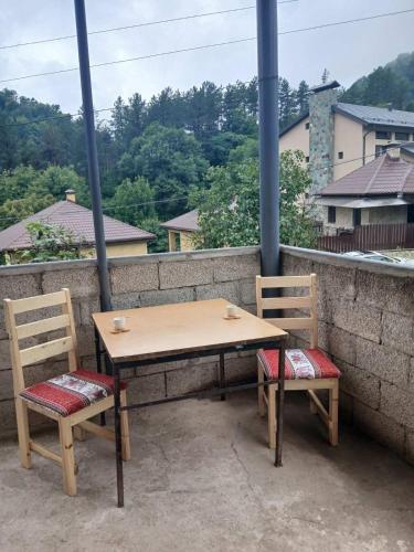 a table and two chairs sitting on a balcony at Dilijan Theghut Hotel in Tʼeghut