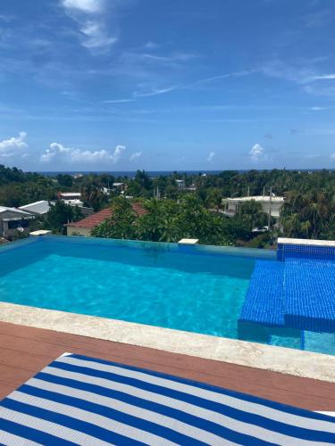 a swimming pool with a view of the city at Hotel Down Town Cabrera in Cabrera