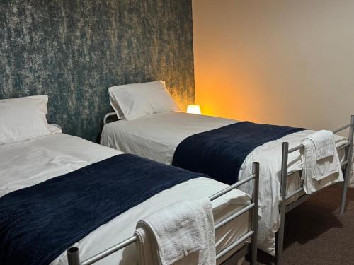 two twin beds in a room with at LHChomeway in Earley