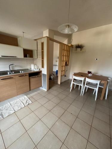a kitchen with a table and chairs and a table and a kitchen at Il Desiderio in Angri