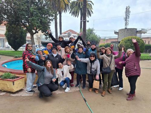 a group of people posing for a picture at Hostal Casa Amarilla San Vicente de Tagua Tagua in San Vicente de Taguatagua