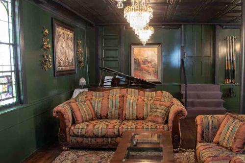 a living room with a couch and a chandelier at The Pulpit House 