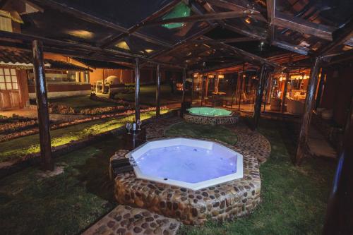 a backyard with a jacuzzi tub in a house at Kutimuy Lodge in Urubamba