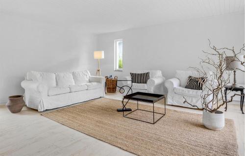a white living room with a white couch and a table at 3 Bedroom Awesome Home In Otterup in Otterup