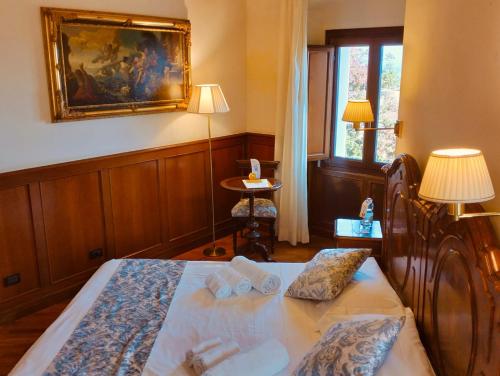 a bedroom with a bed and a painting on the wall at Hotel Foresteria Baglio Della Luna in San Leone