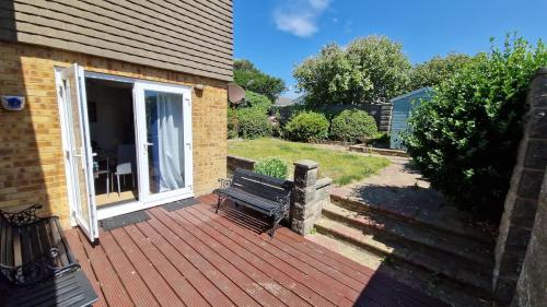 a wooden deck with a bench on a house at 1-Bedroom Annexe in Brighton-Saltdean in Saltdean