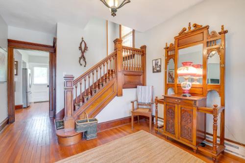 a living room with a wooden staircase and a table at 2 Mi to Steamtown NHS Family Home with Backyard! in Scranton