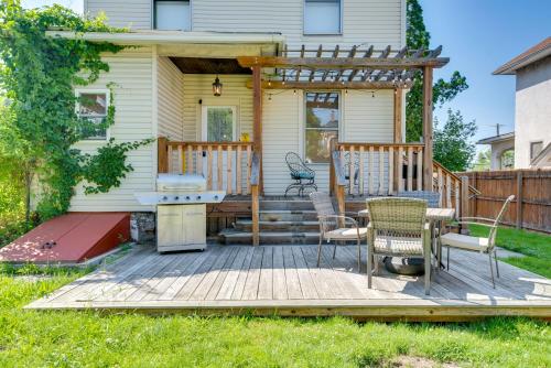 a deck with a grill and chairs on a house at 2 Mi to Steamtown NHS Family Home with Backyard! in Scranton
