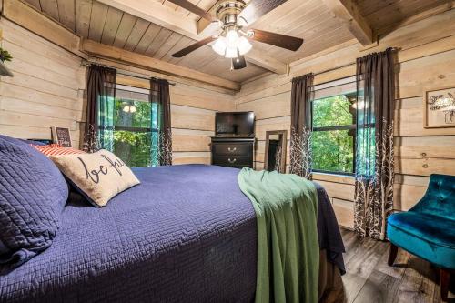 a bedroom with a bed and a ceiling fan at Unique Charm, Central Location, Hot Tub, Games in Sevierville