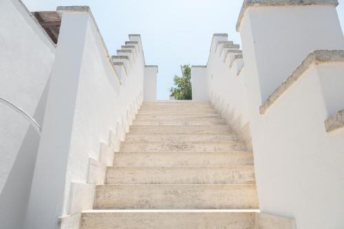 a stairway leading up to a building with white walls at Casa Vacanze Dea in Nardò