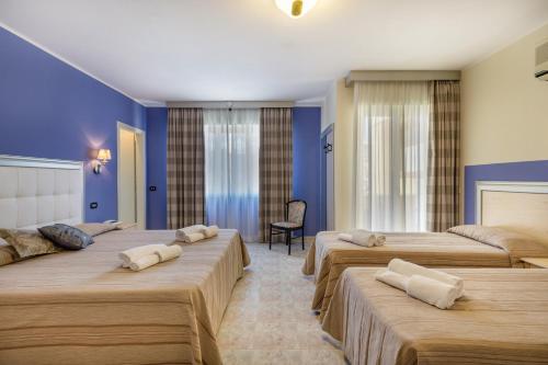 Postel nebo postele na pokoji v ubytování Hotel Rosa dei Venti