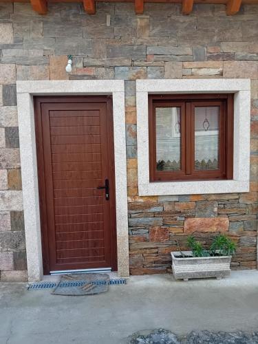 two doors on the side of a stone building at Little House in Miranda do Douro