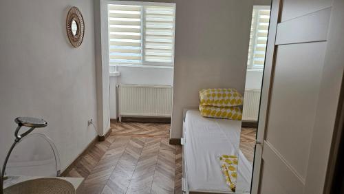 a small room with a chair and a window at Private room at Ceausescu's place in Old City Unirii Square in Bucharest
