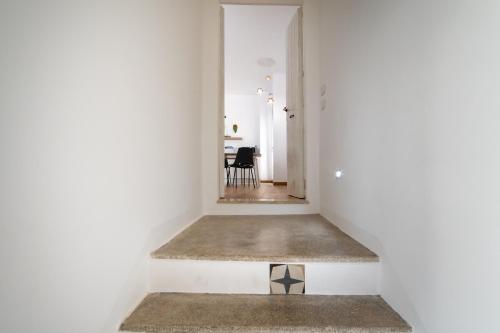 a hallway with white walls and a floor with a rug at Casa Vacanze Dea in Nardò