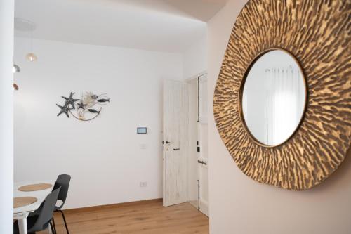 a mirror hanging on a wall in a dining room at Casa Vacanze Dea in Nardò