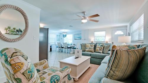 a living room with couches and a dining room at Coastal Cottage in Anna Maria