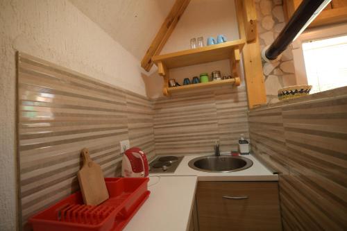 a small kitchen with a sink and a sink at Durmitor Bungalows in Žabljak