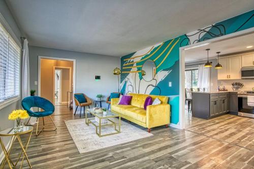a living room with a yellow couch and a kitchen at Rocksteady Atlanta Decatur in Decatur
