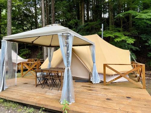 a tent with a table and chairs on a wooden deck at Riverside Glamping Nuts - Vacation STAY 84524v in Yamakami