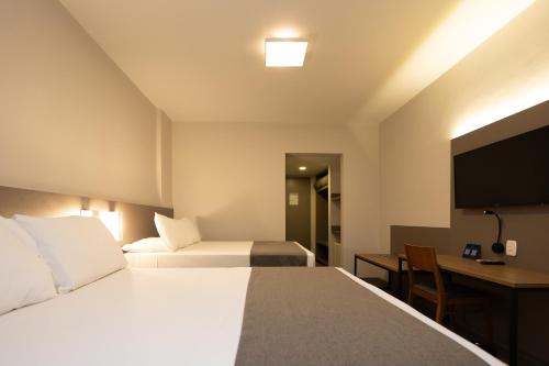 Ένα ή περισσότερα κρεβάτια σε δωμάτιο στο Hotel Caiuá
