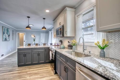 a kitchen with gray cabinets and a sink at Rocksteady Atlanta Decatur in Decatur