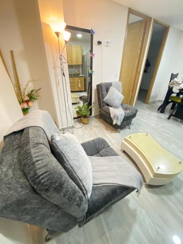 a living room with a couch and a chair at Apartamento Centro Marinilla in Marinilla