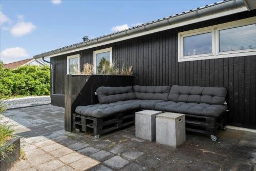 a couch sitting outside of a house at 081-Ringkobing-P-Snejkers-Vej-13 in Ringkøbing