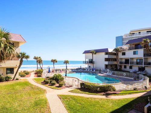 a view of a resort with a swimming pool and the beach at Bent Palm 218 in Ormond Beach