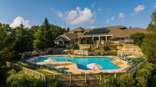 a large swimming pool in front of a house at Dobie 48 with Wintergreen Advantage in Wintergreen